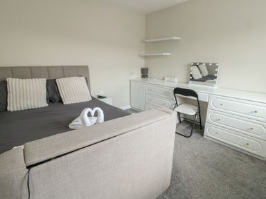 A bedroom with a bed and dresser at 9 Beckett Close Colwyn Bay