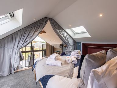A bedroom with a bed and rolled towels under skylights at Hare's Hill in Thornton-Le-Dale