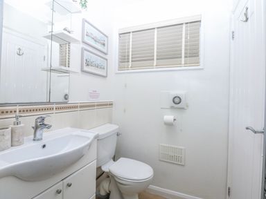A bathroom featuring a sink and toilet at Oakley View Apartment in Porthmadog