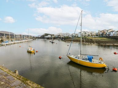 A marina with boats on water at Oakley View Apartment in Porthmadog