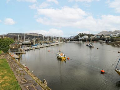 A marina with boats in water at Oakley View Apartment in Porthmadog