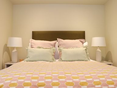 A bed with pillows and lamps on bedside tables in a bedroom at Mavericks Wave in St Agnes