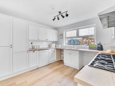A kitchen with a sink and dishwasher at Palm House in Newquay