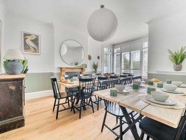 A dining room with a table set for meals at Palm House in Newquay