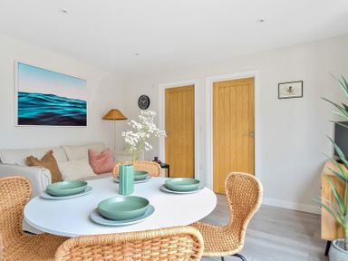 A dining room with a table and chairs at Palm House in Newquay