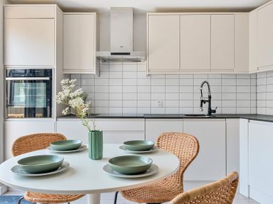 A kitchen with a round table and chairs at Palm House in Newquay