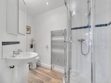 A bathroom with a sink, toilet, and shower at Palm House in Newquay