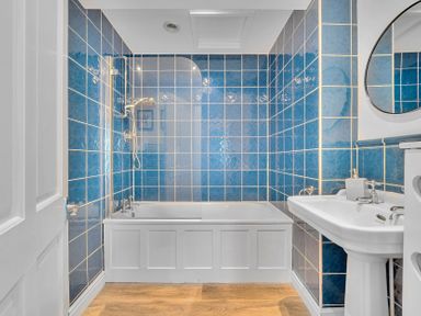A bathroom with a bathtub and sink at Palm House in Newquay