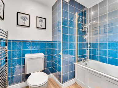 A bathroom with a bathtub and shower at Palm House in Newquay