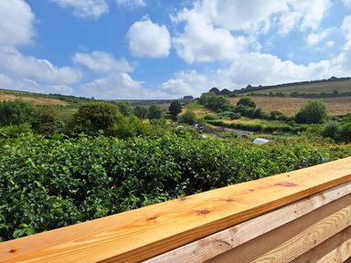A landscape view with greenery and hills at The Halt in Maiden Newton