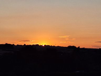 A sunset over the hills at The Halt in Maiden Newton
