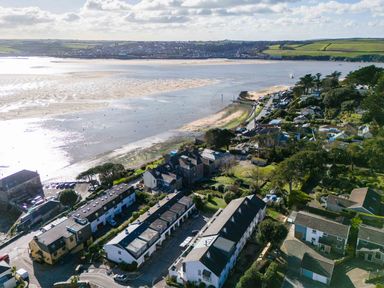 An aerial view of houses by a beach and water with boats in the distance at Slipway 14 in Rock