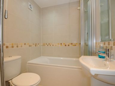 A bathroom with a toilet bathtub and sink at Slipway 14 Rock