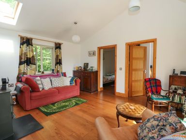A living room with a sofa and a coffee table at Delfryn in Llandeilo