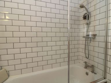 A bathroom with a shower and bathtub at Delfryn in Llandeilo