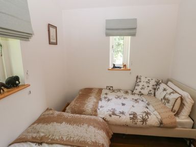 A bedroom with two beds and animal figurines at Delfryn Llandeilo near Llandeilo