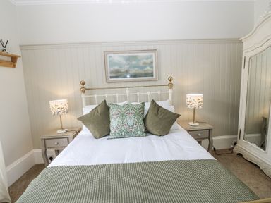 A bedroom with a bed and lamps at 11A High Street Jedburgh