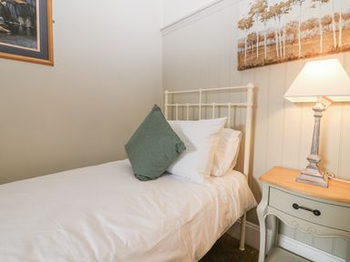 A bedroom with a bed and lamp at 11A High Street, Jedburgh