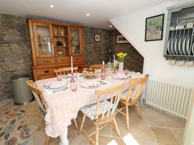 A dining room with a wooden table and chairs at The Museum in Nenthead