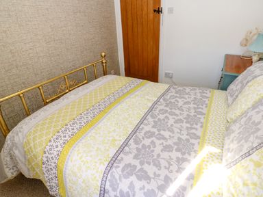 A bedroom with a bed and a bedside table at The Museum in Nenthead