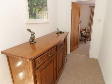 A hallway with a console table and two rabbit figurines at The Museum in Nenthead