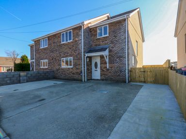 A house with a driveway and fence at 15 Llys Tegeirian Llangristiolus near Llangefni