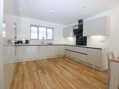A kitchen with cabinets and countertop at 15 Llys Tegeirian in Llangristiolus near Llangefni