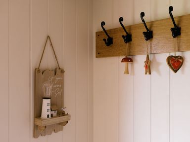 An entryway with wall hooks and decorative items at Bonnie's Shepherds Hut at Shepherds Lodge Retreat and Wellness Bottesford near Redmile and Vale of Belvoir