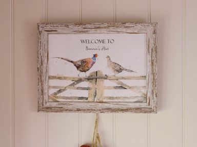 A welcome sign with birds and fence at Bonnie's Shepherds Hut at Shepherds Lodge Retreat and Wellness Bottesford near Redmile and Vale of Belvoir