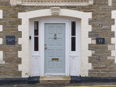 A front entrance door with decorative panels and side windows at Captain's Walk in Newquay