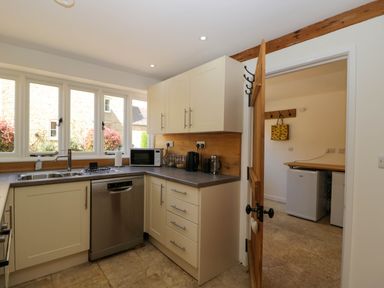 A kitchen with cabinets dishwasher microwave and a sink at Home Farm Barn Todenham near Moreton-In-Marsh