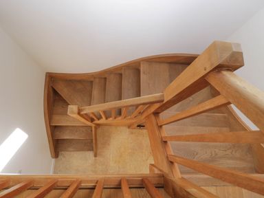 A wooden staircase with handrails and tiled flooring at Home Farm Barn in Todenham near Moreton-In-Marsh