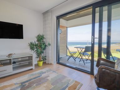 A living room with a television and couch at Apartment 8 