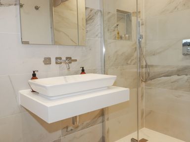 A bathroom with a sink and shower at Apartment 8