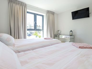 A bedroom with two beds and a window at Apartment 8 