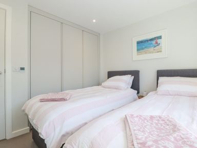 A bedroom with two beds and a wardrobe at Apartment 8 in 