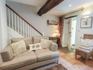 A living room with a sofa and coffee table at Daffodils in Ambleside