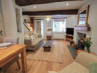 A living room with a coffee table and seating area at Daffodils in Ambleside