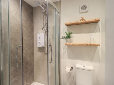 A bathroom with a shower and toilet at Daffodils in Ambleside
