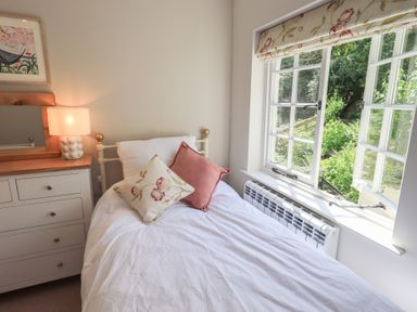 A bedroom with a bed and lamp at Daffodils in Ambleside