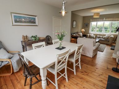 A dining room with a table and chairs at Driftwood in 