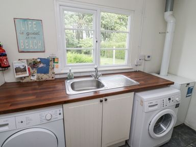 A laundry room with a sink and appliances at Driftwood