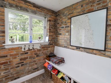 A utility room with a bench and map on the wall at Driftwood
