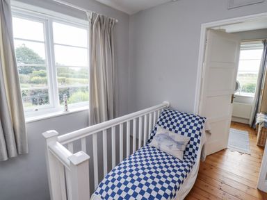 A bedroom with a bed and window at Driftwood