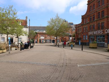 An outdoor area with trees and people at Apartment 1 Brewers Quay in Weymouth