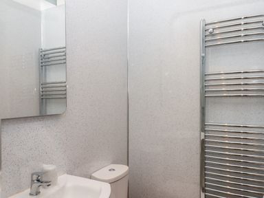 A bathroom with a sink faucet toilet mirror and a heated towel rail at West View in Northlew near Hatherleigh