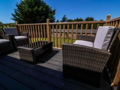 A deck with outdoor chairs and a table at West View near Hatherleigh