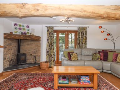 A living room with a sofa and coffee table at Swallows Reach in Halwell