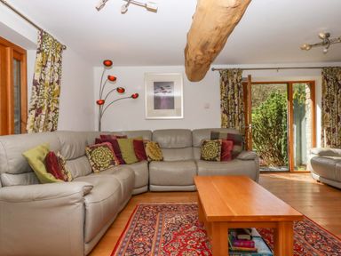 A living room with a sofa and coffee table at Swallows Reach Halwell