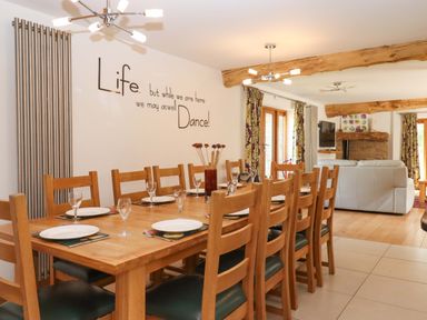 A dining room with a table set for dinner at Swallows Reach Halwell
